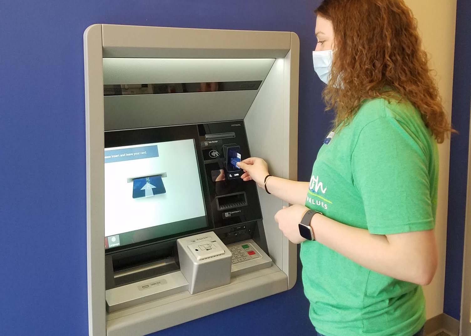Tracy making a transaction at the ITM